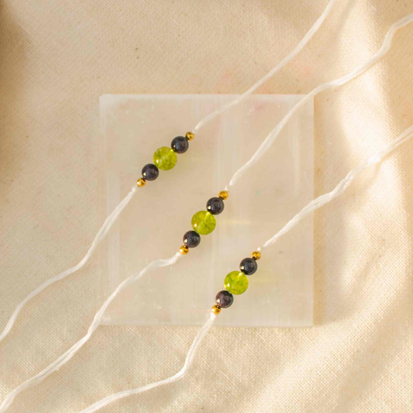 green peridot and red garnet rakhi