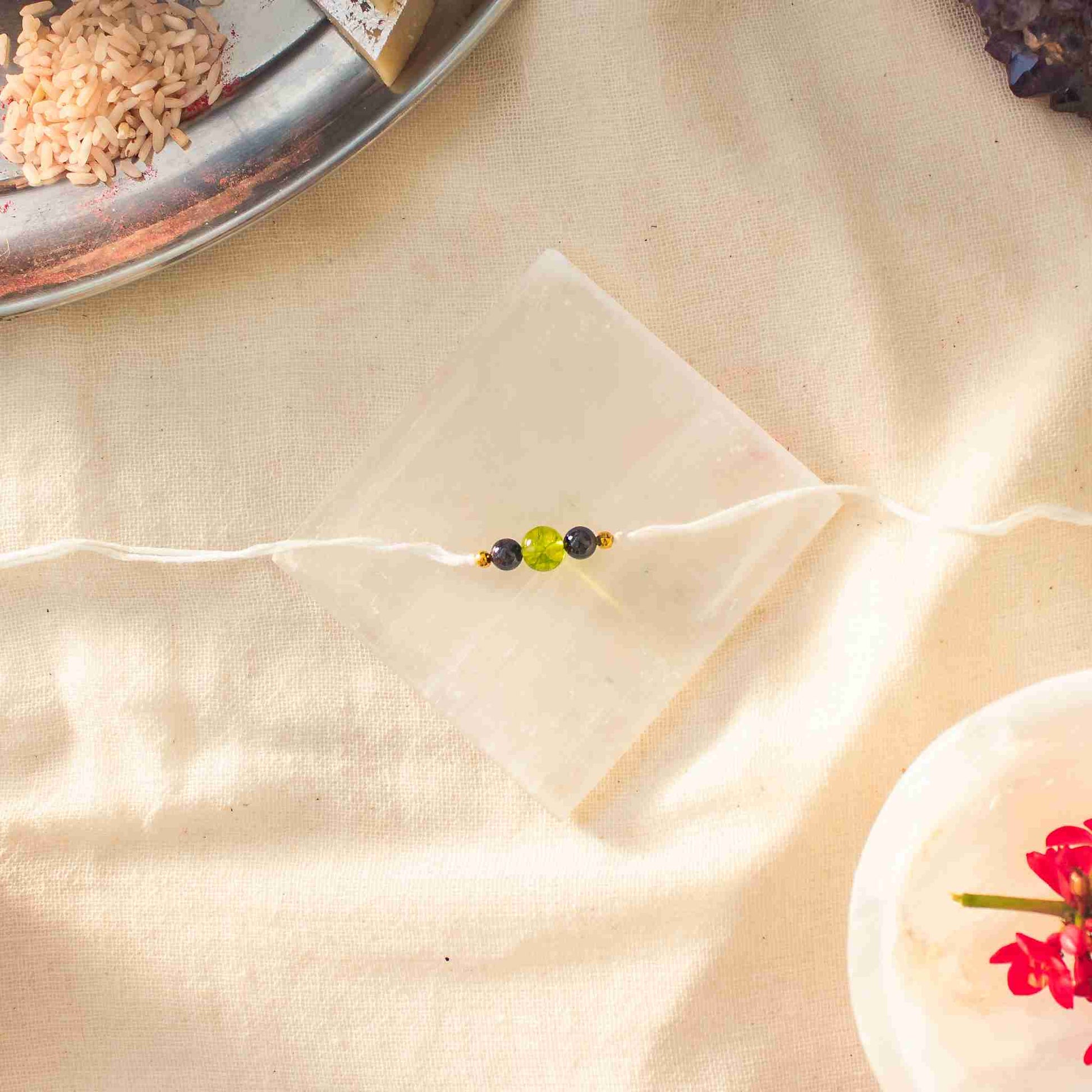red garnet bead rakhi with peridot