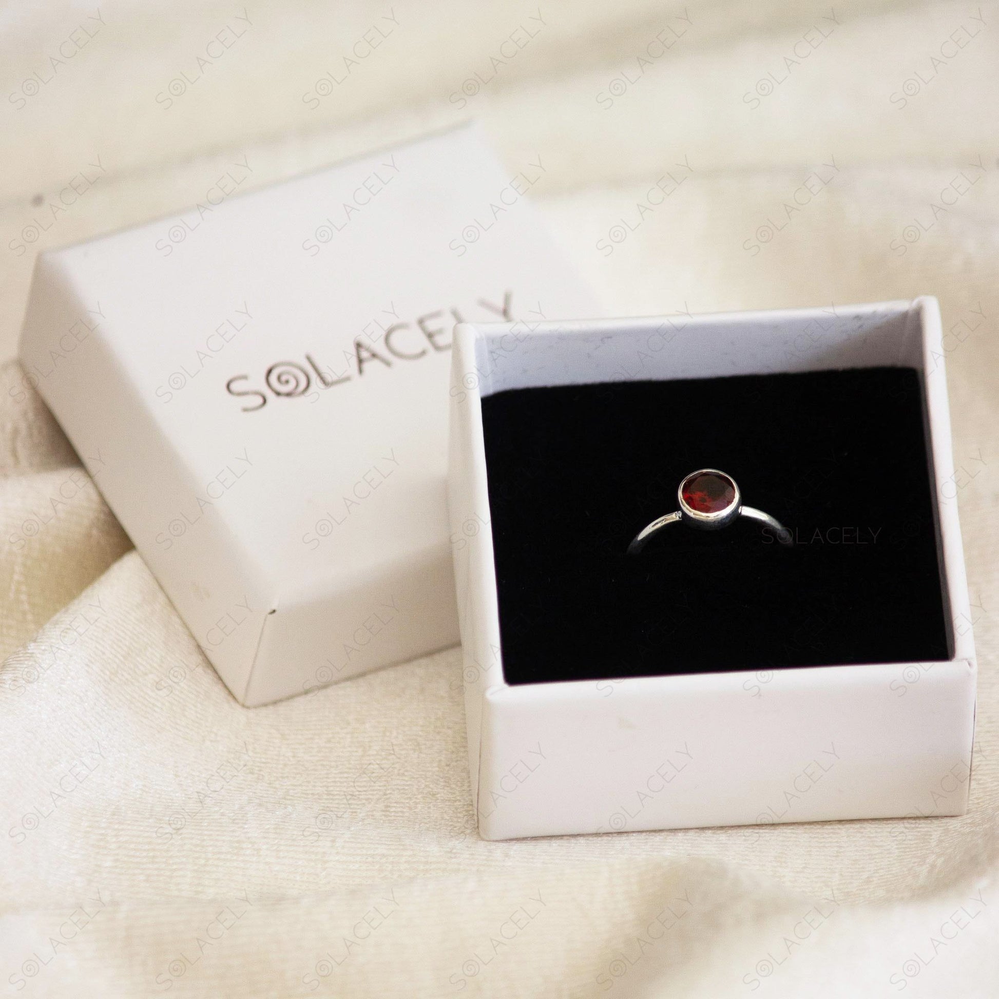 luxurious sterling silver ring featuring red garnet stone