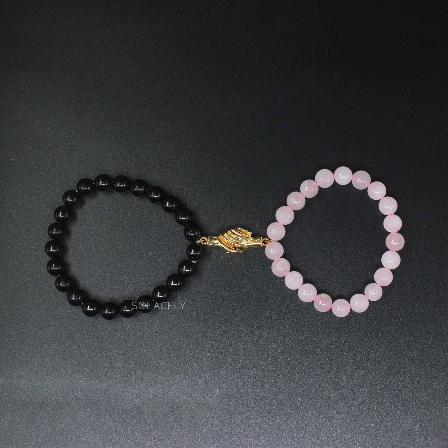 rose quartz and black tourmaline holding hands