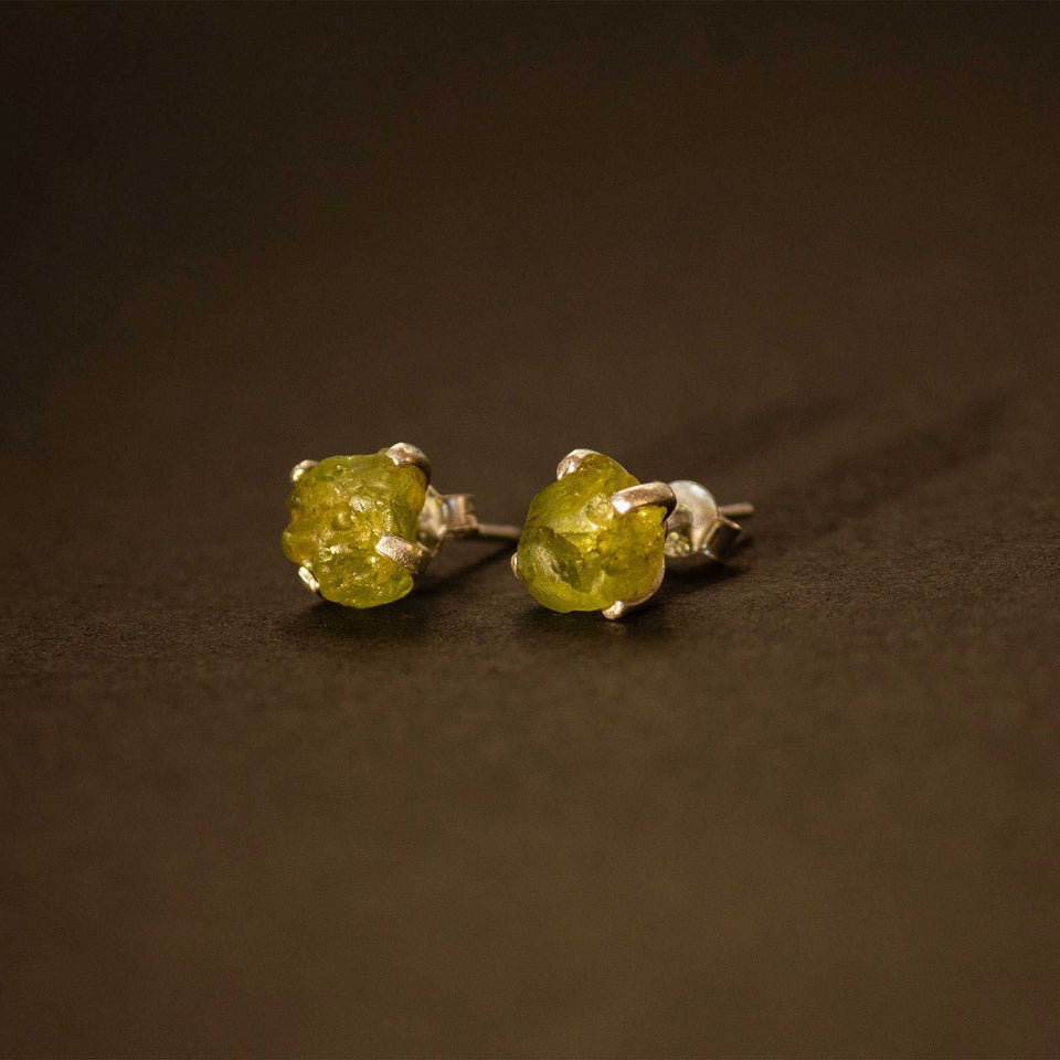 silver earrings with raw peridot