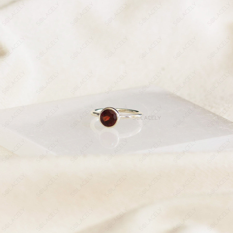 sterling silver band with rich red garnet jewel