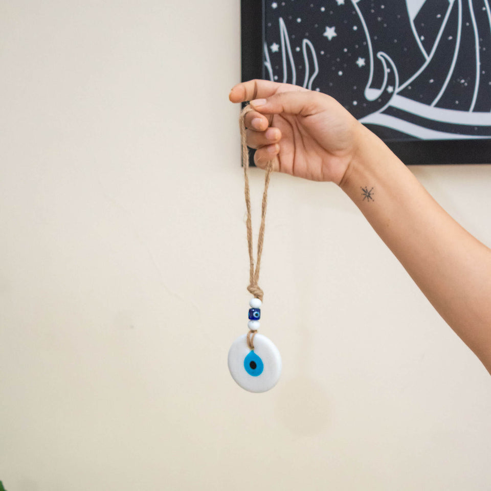 white evil eye wall hanging